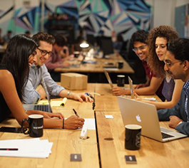 Five individuals sit around a table at Columbia Startup Lab